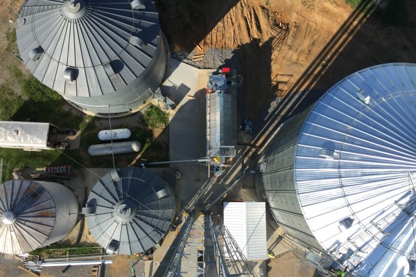 sky view shot of four different sized grain bins