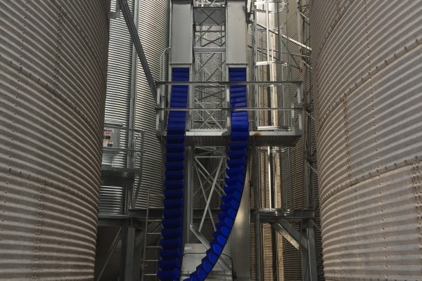 small working space between grain bins with blue parts