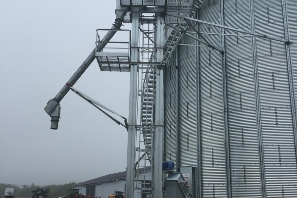 stairs on the side of a grain bin during a cloudy and foggy day