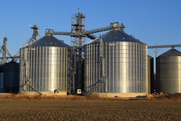 two Brock grain bins with more behind them in a large system