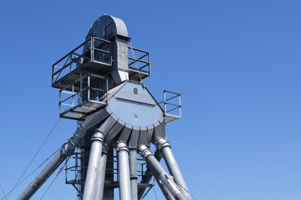 top of a metal landing structure in front of a blue sky
